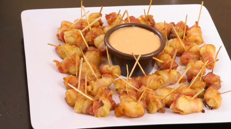 A plate of bacon-wrapped water chestnuts set on a table