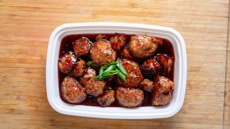 A container of grape jelly meatballs