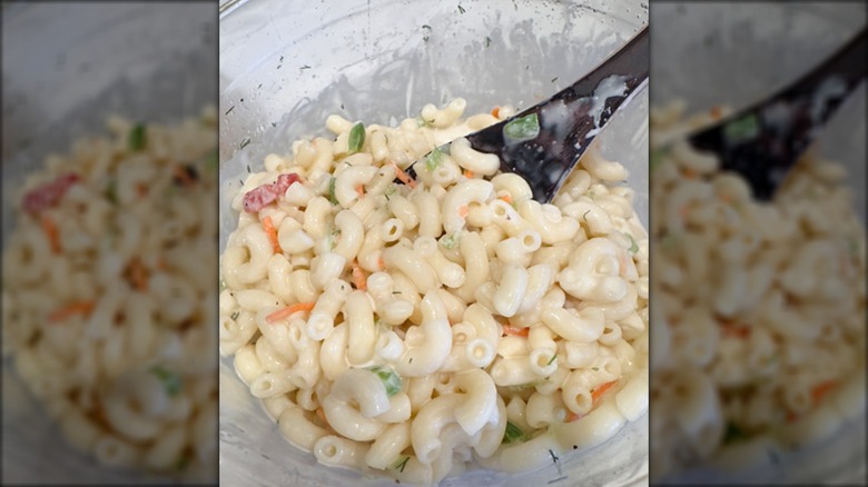 A bowl of macaroni salad, mirrored
