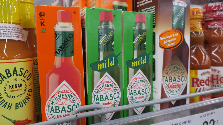 tabasco hot sauce and other hot sauce varieties on store shelf