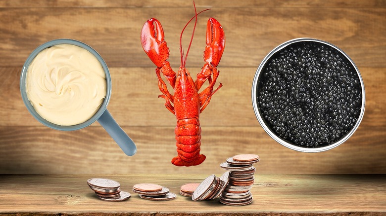 Fondue, lobster, caviar, and pennies on a wooden backdrop