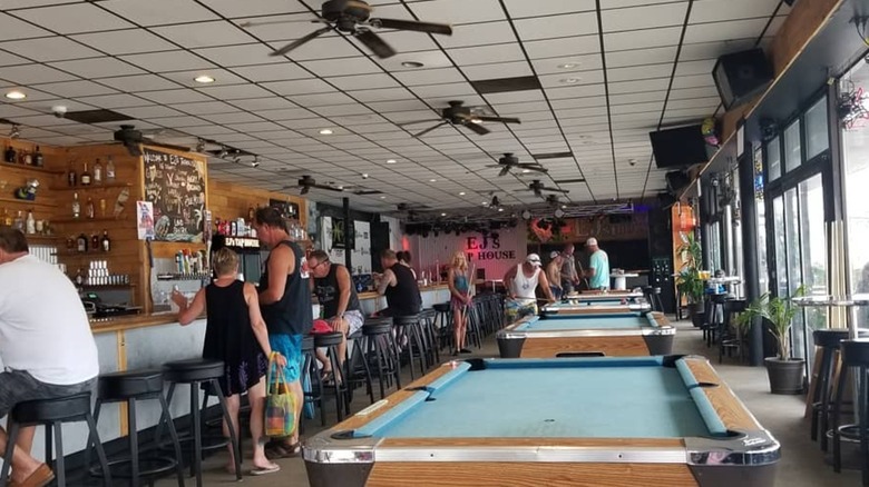 Interior of EJ's tap house with long bartop and pool tables