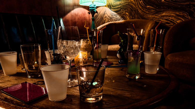 Empty drinks on a table in a dimly lit bar