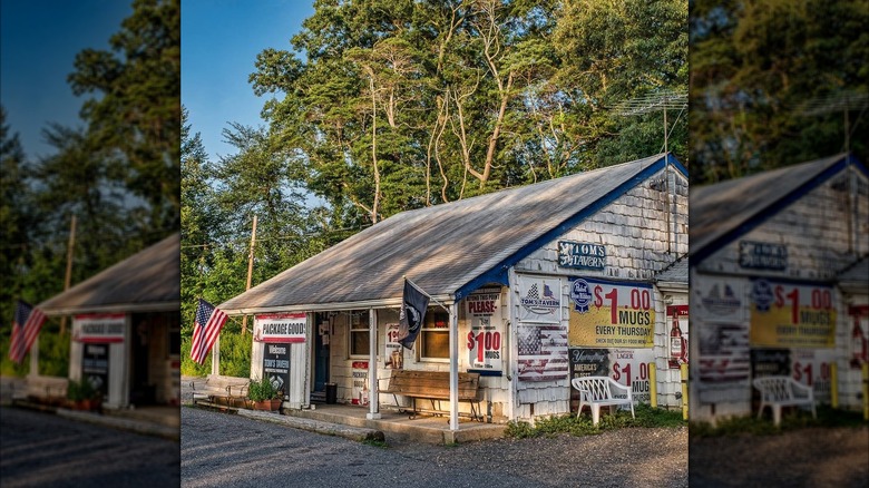 Exterior shot of Tom's Tavern, small white house in gravel parking lot
