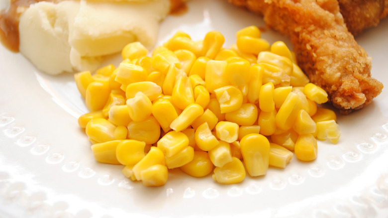 KFC corn on a white plate with chicken