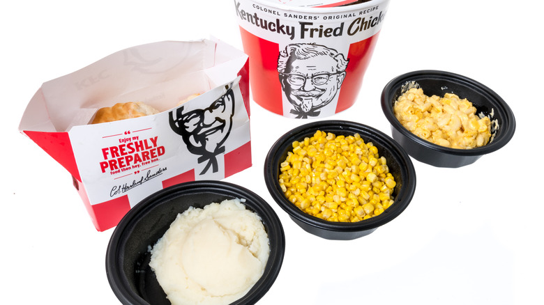 KFC sides in black bowls with bucket and bag in background