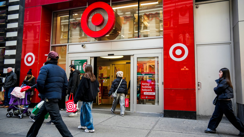 Target store front with shoppers walking and standing in front of the entrance