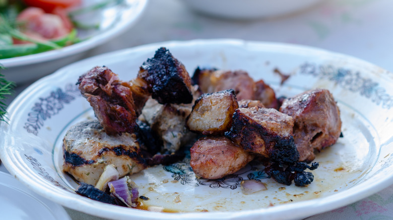 Leftover grilled meat on a white plate