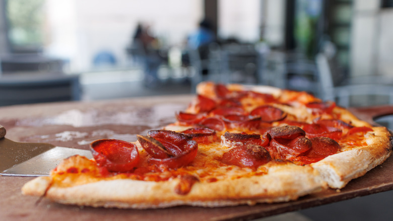 Up-close leftover pizza on a board