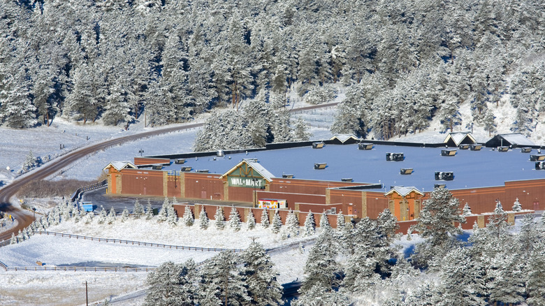 Walmart in Colorado surrounded by pine trees and snow