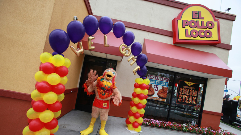 A chicken mascot in front of an El Pollo Loco restaurant