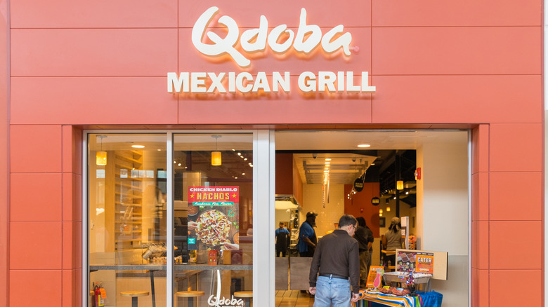 Exterior of a Qdoba Mexican Grill with a customer walking in