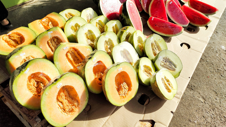 Cantaloupes, honeydews, and watermelons cut in half at open air market