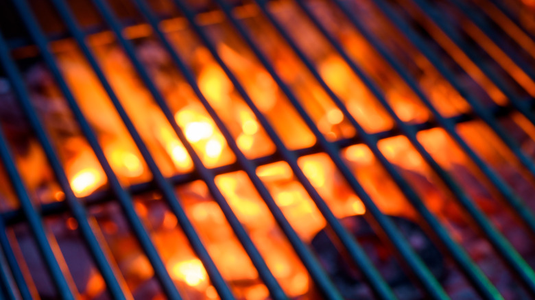 Hot grill grates with flames beneath