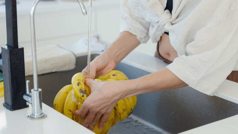 Woman washing bananas