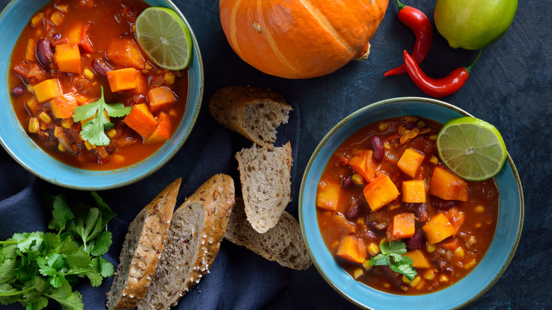 Chili with pumpkin, bread, lime, cilantro