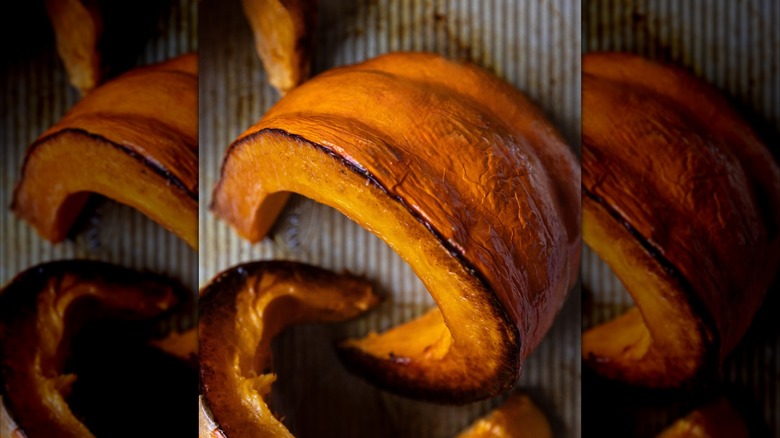 Slices of pumpkin on baking sheet