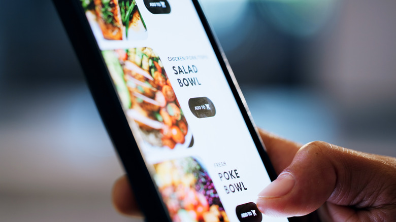 A person on a smartphone looking at an online menu