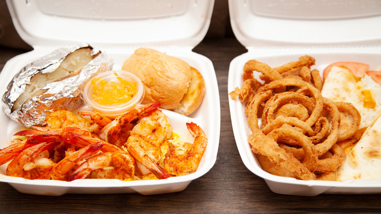 A variety of takeout food in white carryout containers