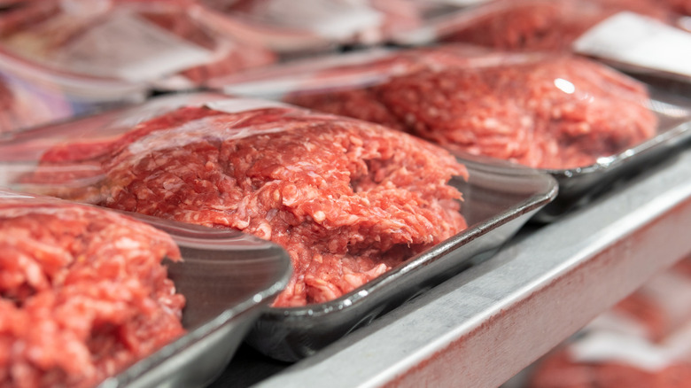 Ground meat packages on display in a supermarket refrigerated shelf