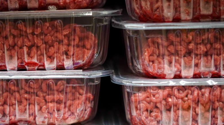 Packages of ground meat on a refrigerated store shelf
