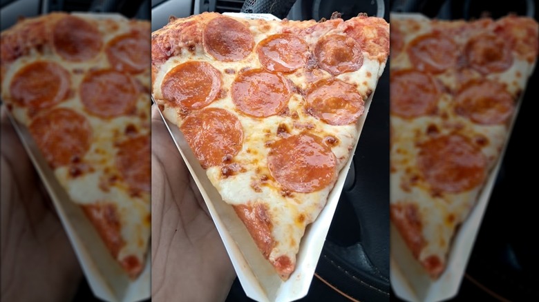 Close-up of a slice of Casey's pepperoni pizza in someone's hand.