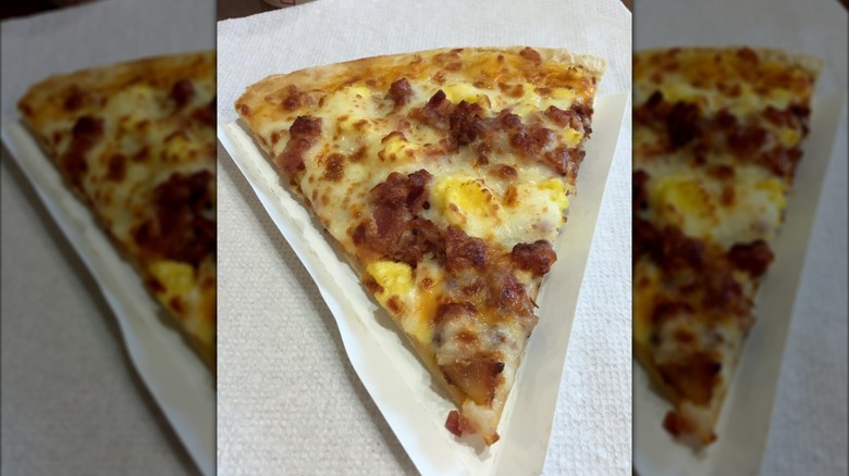 A slice of Casey's breakfast sausage pizza on a napkin.
