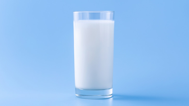 glass of milk on blue background