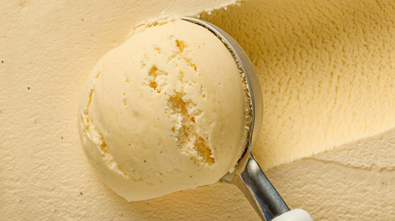 close up of scoop pulling up vanilla ice cream