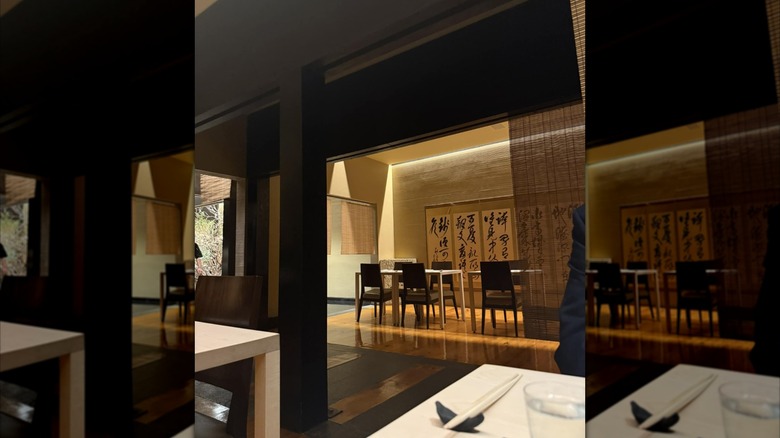 Elegant interior of Masa restaurant showing chairs, tables, and Japanese lettering on the walls