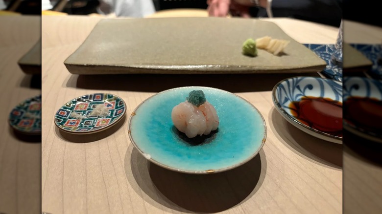 Raw fish on blue plate at Noda