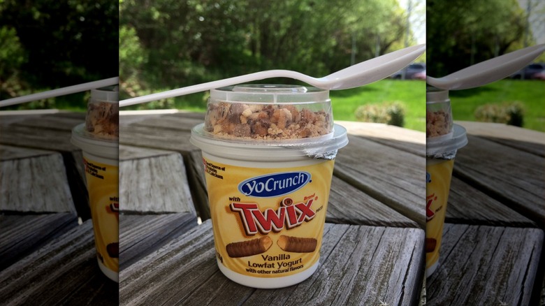 YoCrunch TWIX yogurt container with spoon on table