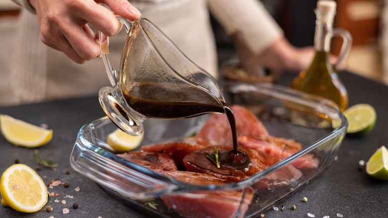 Marinade being poured over meat
