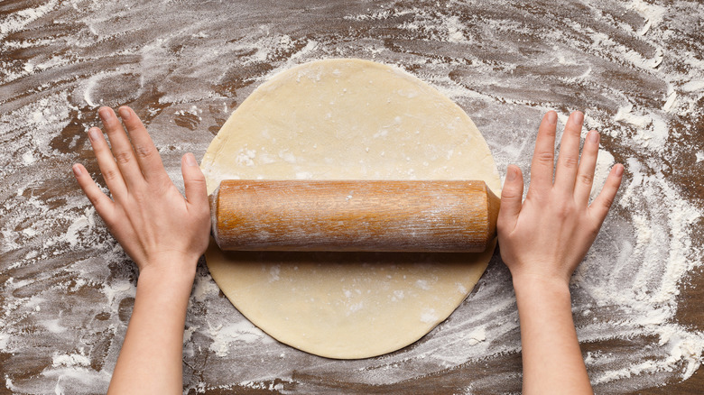 Person rolling our pastry dough
