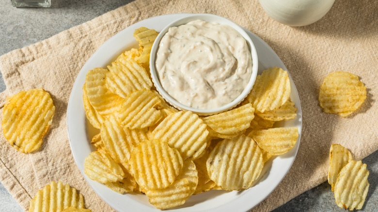 A ramekin full of California dip (French onion dip) surrounded by potato chips