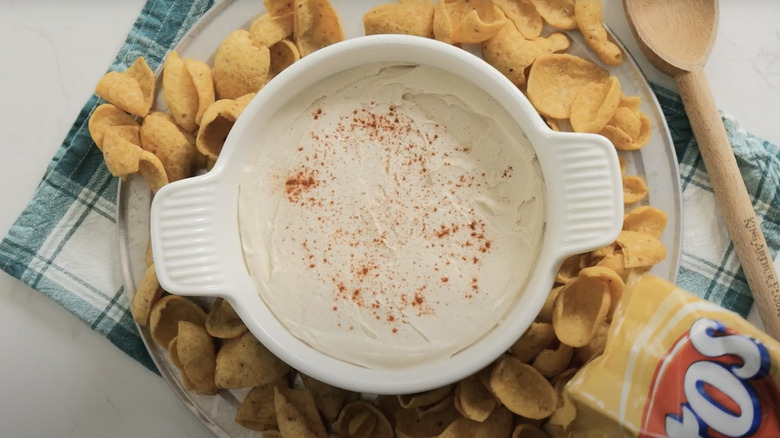 A bowl of Philly Hostess dip surrounded by corn chips