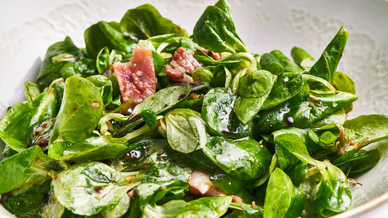 Bacon on spinach salad