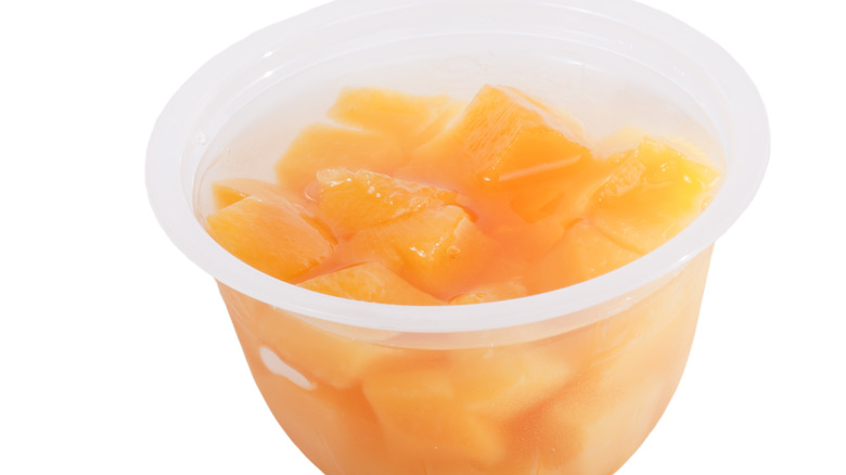 Extreme close-up of a cup of cling peaches in a to-go cup