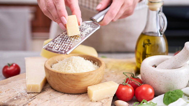 Cheese being grated into bowl