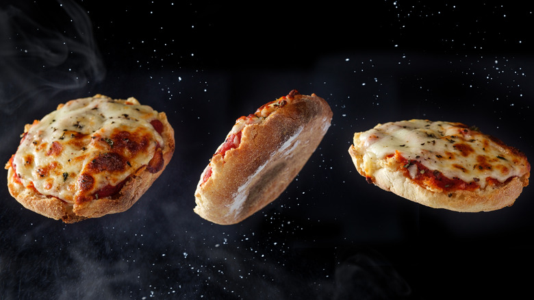 English muffin pizzas floating in the air