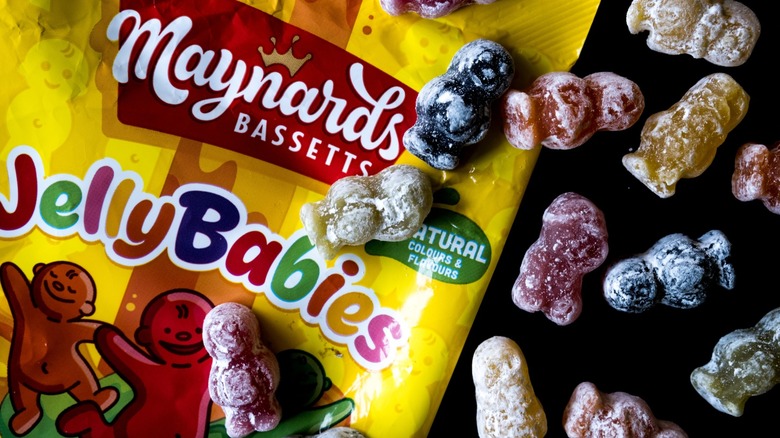 A packet of Jelly Babies and loose Jelly Babies