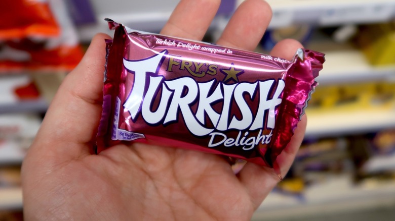 A person holds a Turkish Delight in the palm of their hand in an American store