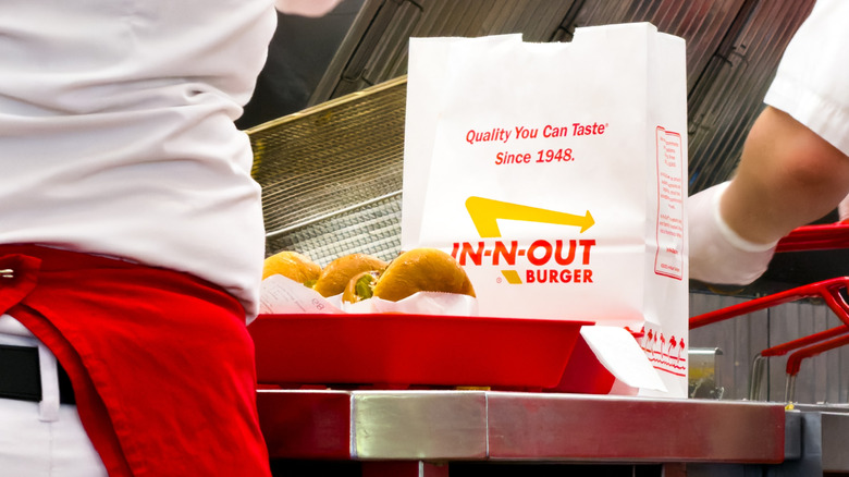 Kitchen workers prepare food in an In-N-Out kitchen