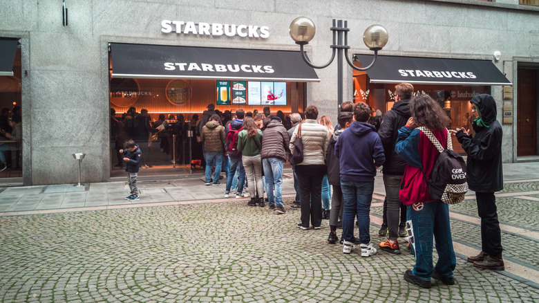 Customers in line outside a Starbucks