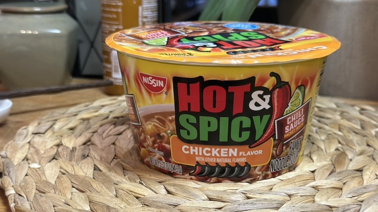 Bowl of Nissin Foods Hot & Spicy Ramen Noodle Soup, Chicken flavor on wicker mat