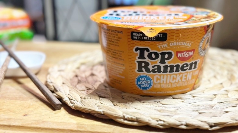 Nissin Foods Top Ramen The Original Ramen Noodle Soup, Chicken Flavor with chopsticks on wicker mat