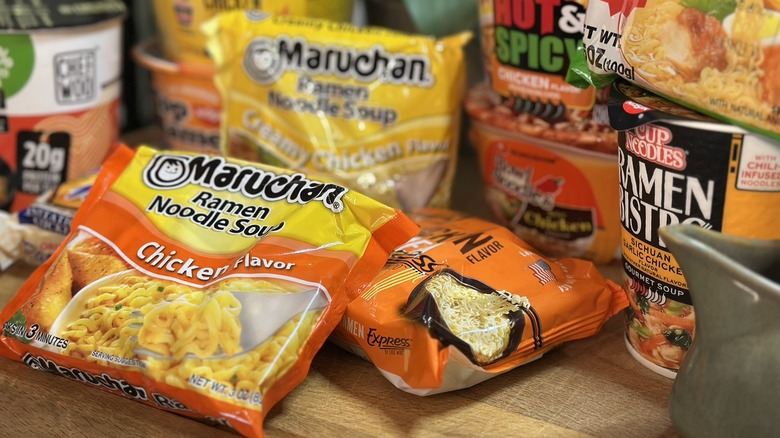 Collection of instant ramen soups on wooden board