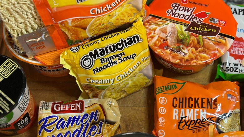 A mix of reviewed instant ramen on a wooden board