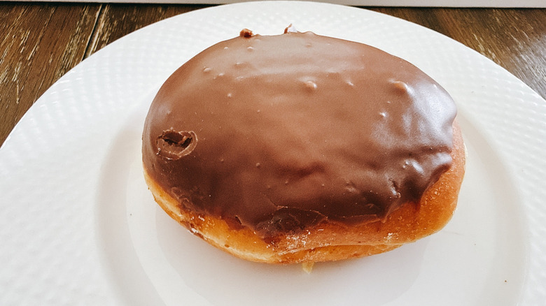 Krispy Kreme Chocolate Iced Custard Doughnut on white plate