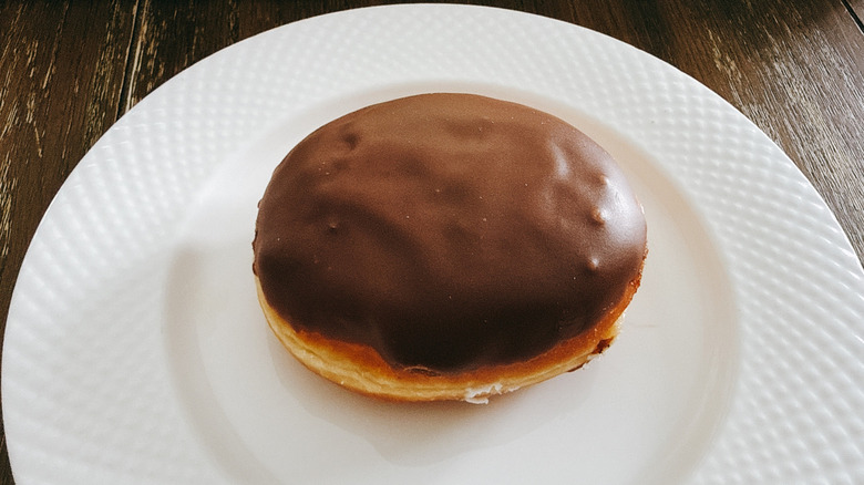 Krispy Kreme Chocolate Iced Kreme Filled Doughnut on white plate